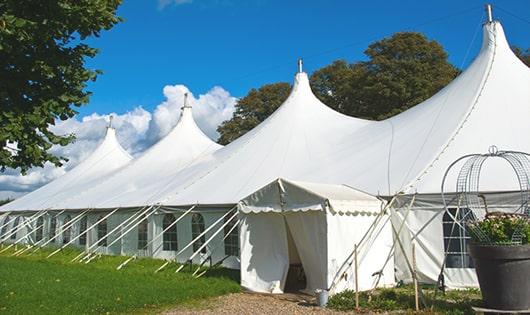 a row of portable restrooms placed outdoors for attendees of a event in Foxfield